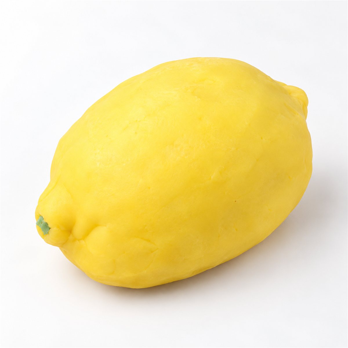 A handmade yellow lemon-design pie with tapered ends and a matte surface on white.